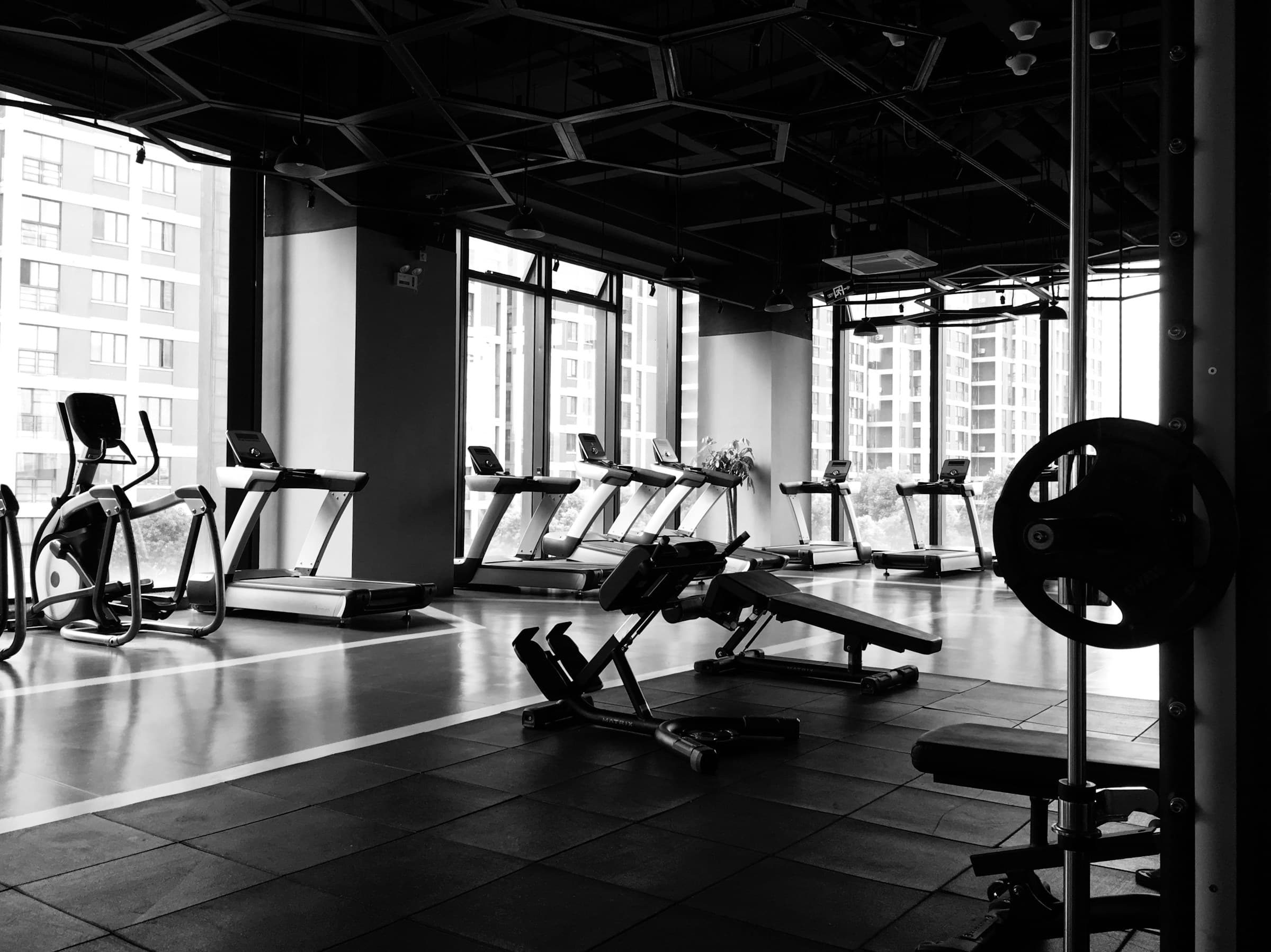 Image of the inside of a commercial gym, the image is in black and white
