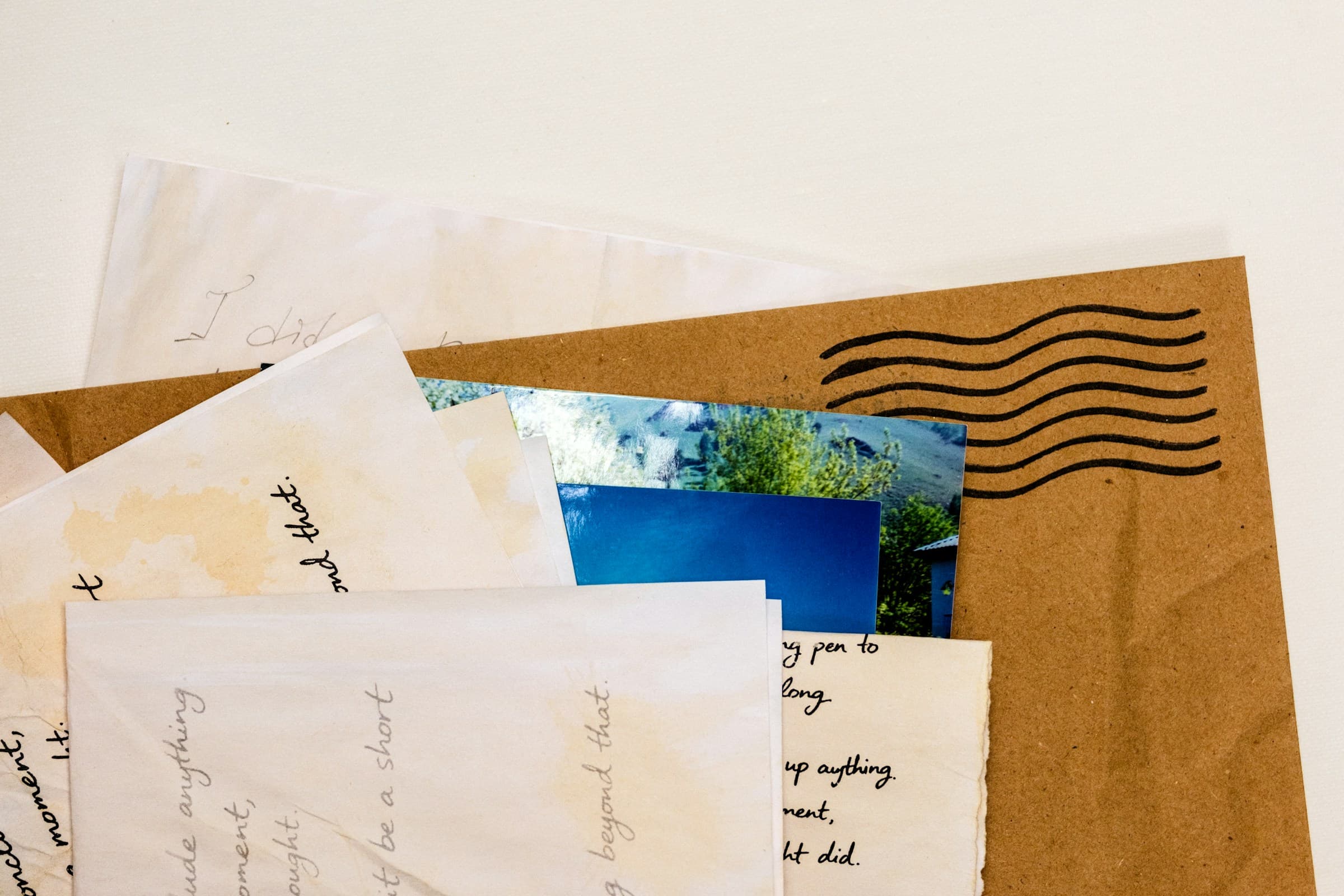 A pile of envelopes, including one large envelope.